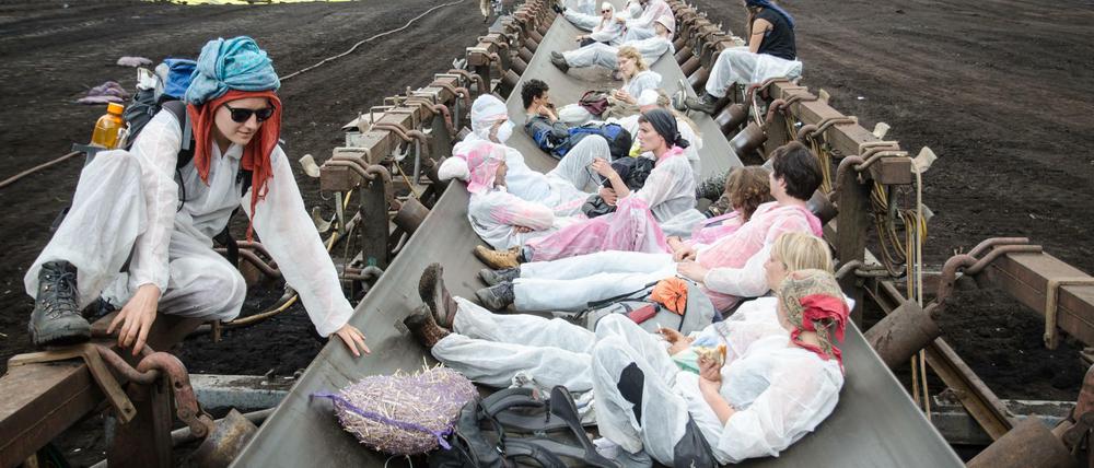 Aktivisten des Protestbündnisses "Ende Gelände" liegen im Braunkohlentagebau Welzow (Brandenburg) auf einem Förderband. 