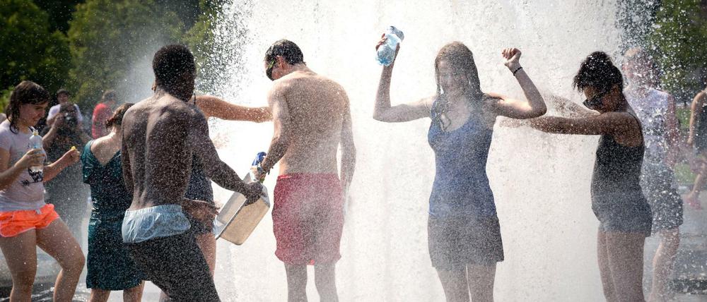 Wasserschlacht-Flashmob am Brunnen im Lustgarten in Berlin-Mitte. Bei 35 Grad Celsius muss man sich zu helfen wissen. 