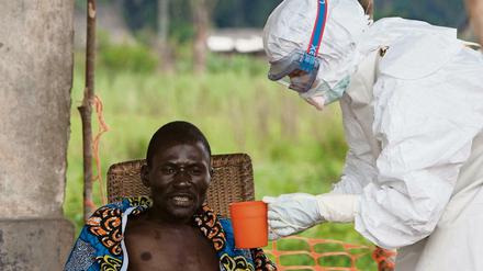Ein Ebola-Patient wird in Afrika von einem Mediziner versorgt. 
