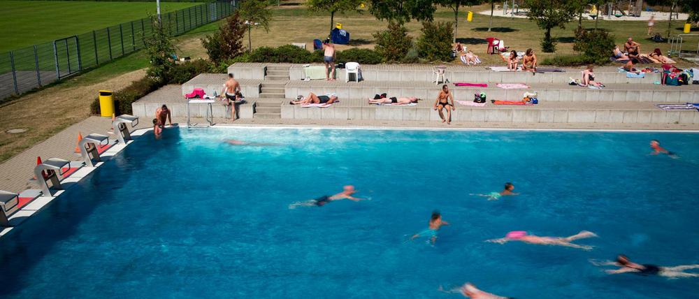 Badegäste schwimmen im Rheinbad. In dem Düsseldorfer Freibad ist es zu einem Streit mit mehreren Hundert beteiligten Badegästen gekommen.