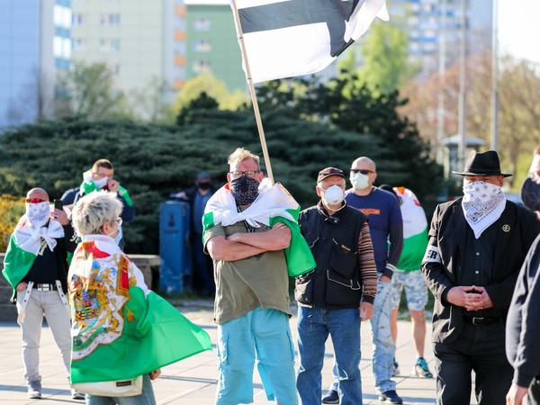 Teilnehmer der rechtsextremen Vereinigung Pro Chemnitz müssen mit Mundschutz gegen die Corona-Maßnahmen demonstrieren.