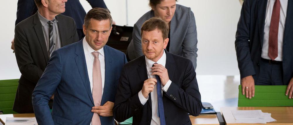 Sachsens Regierungschef Michael Kretschmer (M, CDU) und sein Vize Martin Dulig (vorne l, SPD)